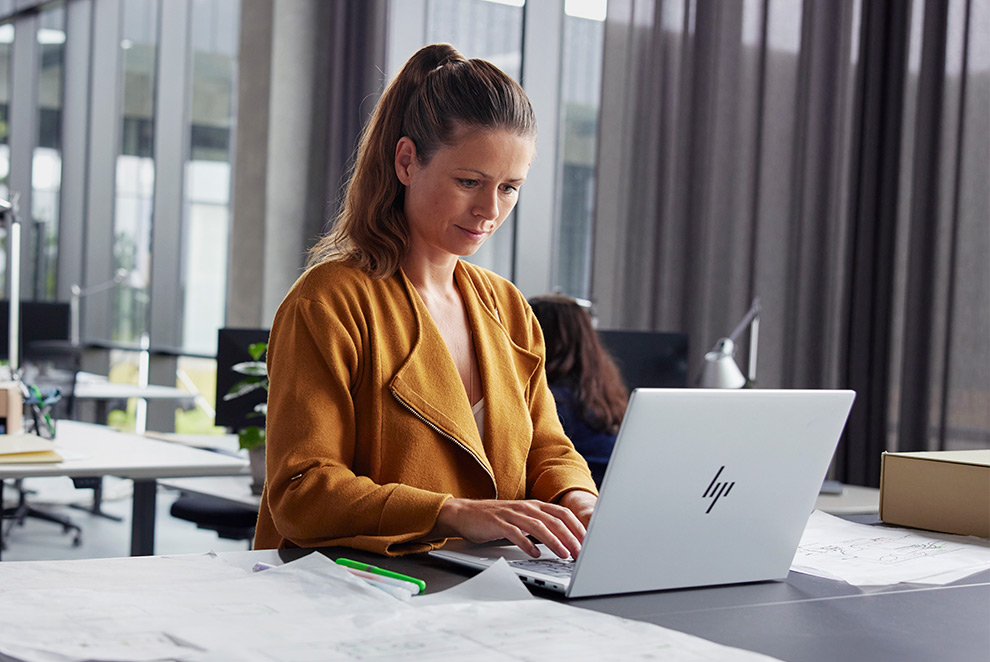 woman is working with EliteBook in an office