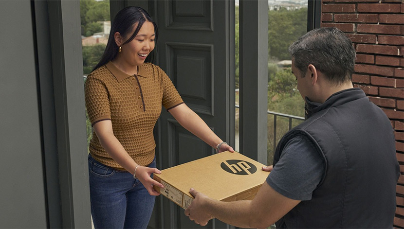delivery man is passing a box to woman