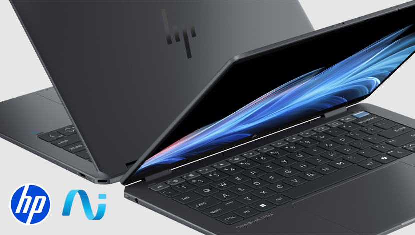 image of two AI laptops sitting on a gray surface
