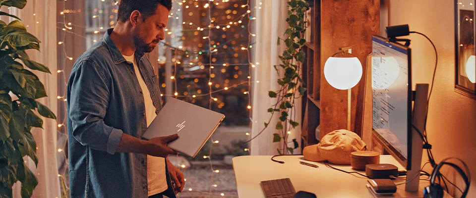person in a home office with holiday lighting decoration