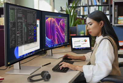 woman working in an office with HP business monitors