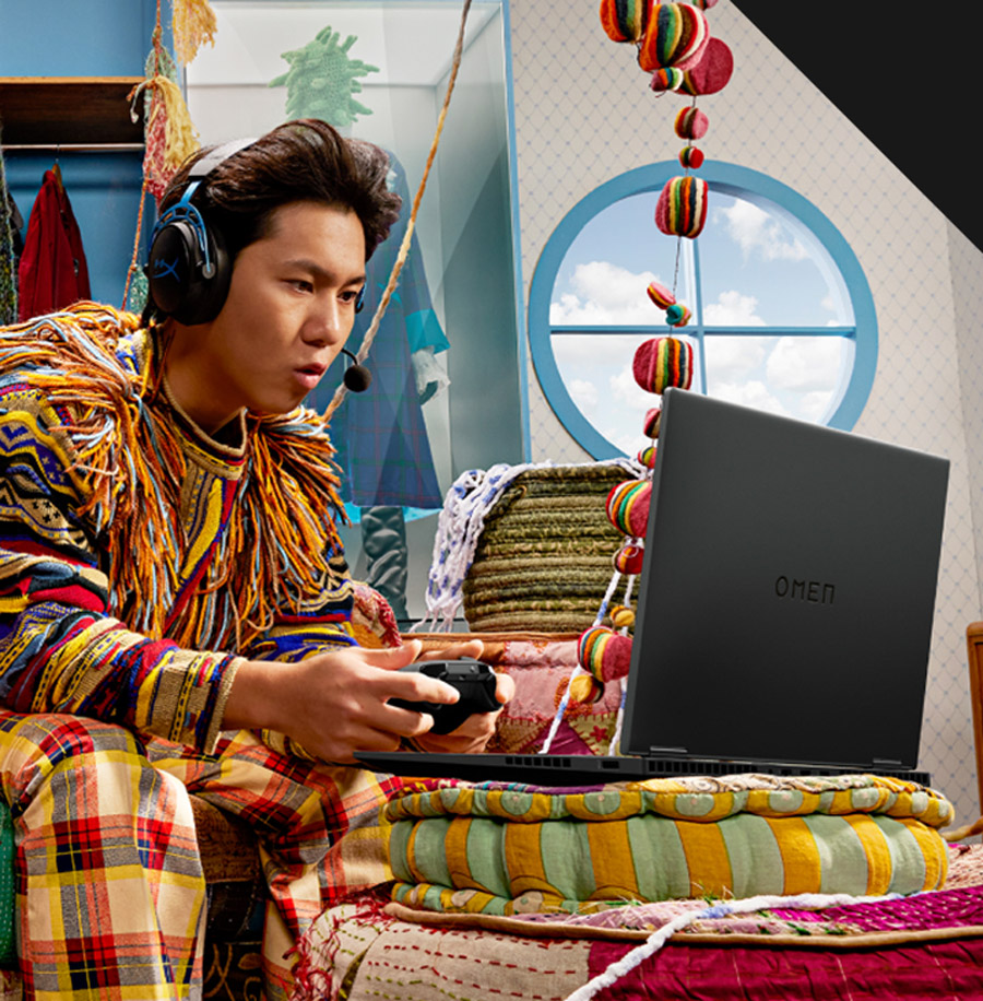 a teenager playing on his OMEN 17 gaming laptop